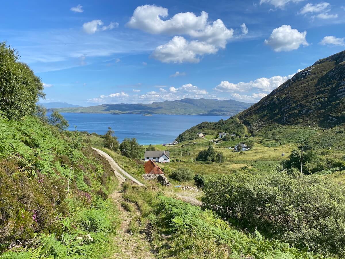 path through lush greenery with a view over Loch Nevis