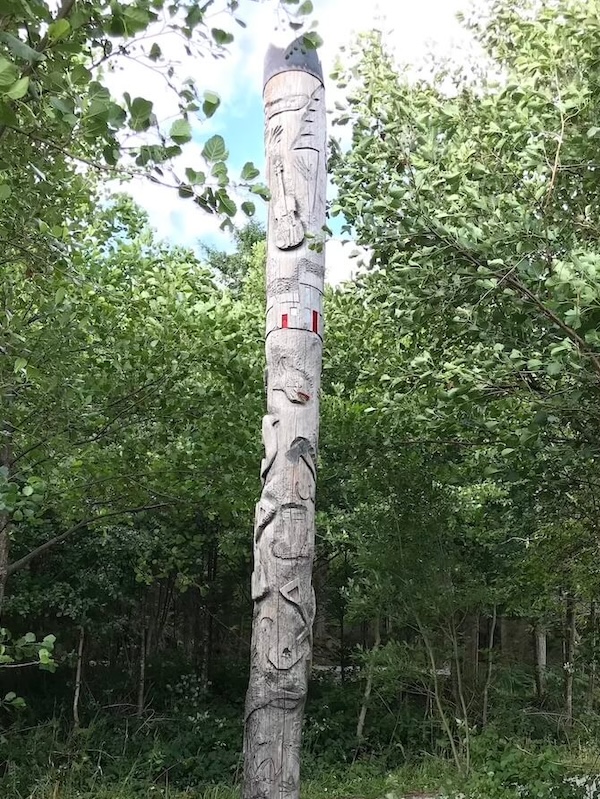 totem pole surrounded by tall green trees on knoydart