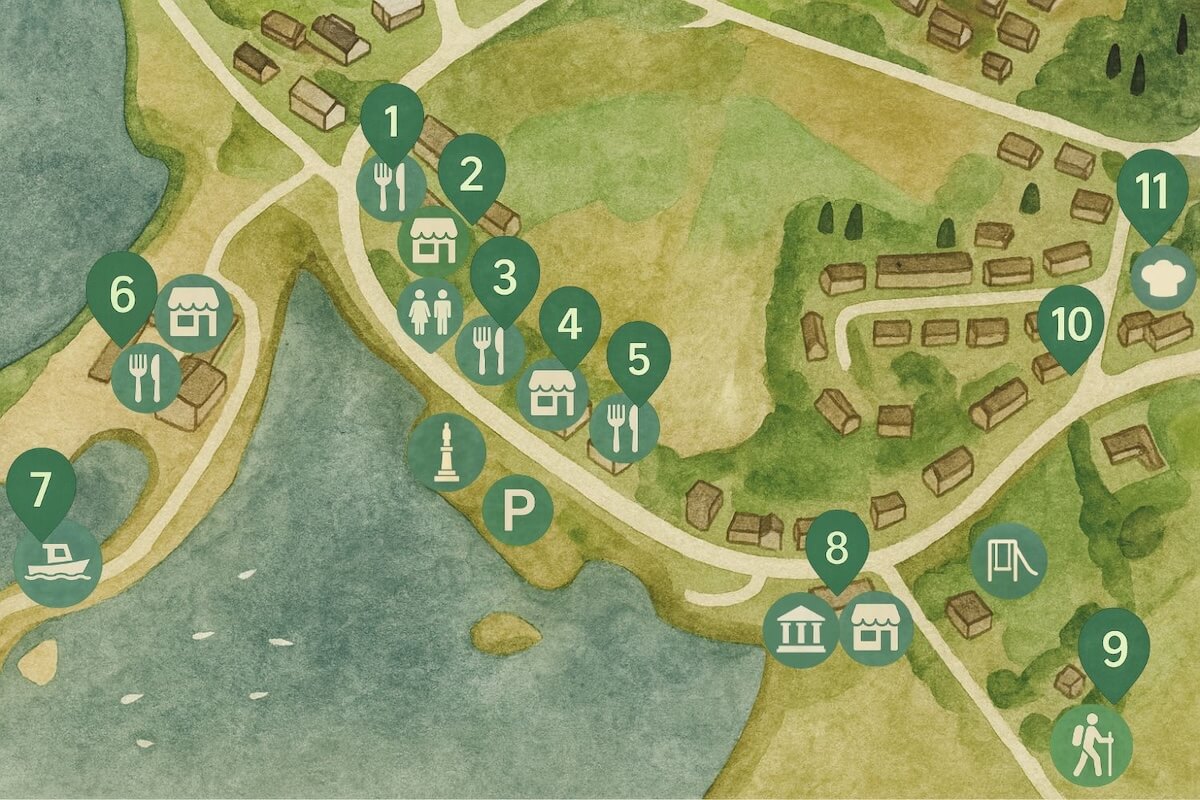 Illustrated map of Arisaig area showing numbered landmarks along roads and shoreline. Icons represent restaurants (knife and fork), shops (market stall), toilets, parking, a monument, a ferry (boat), a museum (classical building), a playground and a hiking trail. Key locations include 1–6 clustered near the shoreline, 7 at the ferry dock, 8–9 in the southern area, and 10–11 further inland near residential houses.